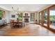 Formal dining room featuring hardwood floors, a cozy fireplace, and abundant natural light through large windows and glass doors at 25808 Sunrise Ln, Golden, CO 80401