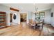Well-lit dining room with hardwood floors, offering a view into an office space and showcasing a display cabinet at 25808 Sunrise Ln, Golden, CO 80401