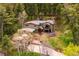 An aerial view of a two story home, including an outdoor deck and a landscaped yard at 25808 Sunrise Ln, Golden, CO 80401