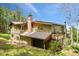 Exterior angle of the home with a side balcony and lush trees surrounding at 25808 Sunrise Ln, Golden, CO 80401
