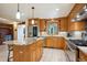 Open kitchen featuring stainless steel appliances, an island with a granite countertop, and abundant counter space at 25808 Sunrise Ln, Golden, CO 80401