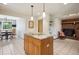 Kitchen island with granite countertop, stainless appliances and seating area with fireplace at 25808 Sunrise Ln, Golden, CO 80401
