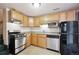 Well-lit kitchen featuring stainless steel appliances and ample wooden cabinet storage at 25808 Sunrise Ln, Golden, CO 80401
