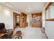 Spacious living room with built-in bookshelves and a cozy reading chair at 25808 Sunrise Ln, Golden, CO 80401