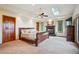 Spacious main bedroom featuring a cozy fireplace, a ceiling fan, and plenty of natural light from skylights and windows at 25808 Sunrise Ln, Golden, CO 80401