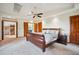 Spacious main bedroom with a ceiling fan, skylight, and ensuite bathroom at 25808 Sunrise Ln, Golden, CO 80401