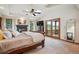 Bright main bedroom features fireplace, private balcony, and vaulted ceiling with skylight at 25808 Sunrise Ln, Golden, CO 80401