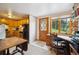 View of kitchen and office area with wooden door and desk in a bright, open space at 25808 Sunrise Ln, Golden, CO 80401