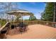 Outdoor deck with an umbrella-covered table and chairs, surrounded by trees and offering a scenic view at 25808 Sunrise Ln, Golden, CO 80401