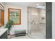Glass shower with natural lighting, bench, and overhead skylight at 25808 Sunrise Ln, Golden, CO 80401