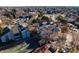 Aerial view of community buildings with tennis courts, parking, mature trees, and blue sky background at 14066 E Stanford Cir # H08, Aurora, CO 80015