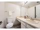 Bright bathroom featuring light colored vanity, tile flooring and large mirror at 14066 E Stanford Cir # H08, Aurora, CO 80015