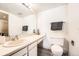 Bright bathroom featuring light colored vanity, tile flooring and large mirror at 14066 E Stanford Cir # H08, Aurora, CO 80015