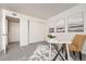 Bedroom features gray carpet, a closet with sliding doors, and an office desk with chair at 14066 E Stanford Cir # H08, Aurora, CO 80015