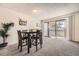 Bright dining area features a sliding door to a balcony, perfect for enjoying meals and the outdoors at 14066 E Stanford Cir # H08, Aurora, CO 80015