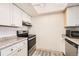 Well-lit kitchen boasts stainless steel appliances and white cabinets, creating a bright and functional space at 14066 E Stanford Cir # H08, Aurora, CO 80015