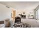 Bright living room featuring neutral decor, plush carpet, and a dining area with seating at 14066 E Stanford Cir # H08, Aurora, CO 80015