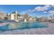 Covered community pool and outdoor lounge area with buildings, landscaping and beautiful blue sky at 14066 E Stanford Cir # H08, Aurora, CO 80015