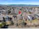 Aerial view of a property situated in a suburban neighborhood with mountain views in the distance at 6725 Lionshead Pkwy, Lone Tree, CO 80124