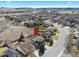 Aerial view of a property in a residential area near open land and rolling hills at 6725 Lionshead Pkwy, Lone Tree, CO 80124