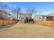 Expansive backyard with lush lawn, deck, patio area, and fencing for a private outdoor space at 6725 Lionshead Pkwy, Lone Tree, CO 80124