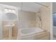 Bathroom featuring stone tile, a built-in jacuzzi bathtub and a pedestal sink at 6725 Lionshead Pkwy, Lone Tree, CO 80124