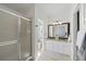 Bathroom featuring tile floors, double sink vanity, large mirror, and glass-enclosed shower at 6725 Lionshead Pkwy, Lone Tree, CO 80124