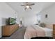 Bright bedroom features ceiling fan, large window, a seating area, and neutral carpeting at 6725 Lionshead Pkwy, Lone Tree, CO 80124