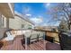 Spacious outdoor deck featuring wooden flooring, a seating area, and a dining table at 6725 Lionshead Pkwy, Lone Tree, CO 80124