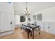 Dining room with natural light, hardwood floors, and modern chandelier at 6725 Lionshead Pkwy, Lone Tree, CO 80124