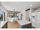 Open kitchen and dining area with white cabinetry, hardwood floors, and stainless steel appliances at 6725 Lionshead Pkwy, Lone Tree, CO 80124