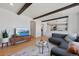 Open-concept living room with hardwood floors, modern decor, and a view into the adjacent kitchen at 6725 Lionshead Pkwy, Lone Tree, CO 80124