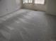 Bright bedroom with modern carpeting, neutral walls and windows with shutters at 6712 E Briarwood Dr, Centennial, CO 80112