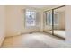 Well-lit bedroom featuring mirrored closet doors at 6712 E Briarwood Dr, Centennial, CO 80112