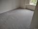 Well-lit bedroom with new carpeting and a large window at 6712 E Briarwood Dr, Centennial, CO 80112