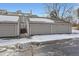 Townhouse exterior with attached garage and snow-covered driveway at 6712 E Briarwood Dr, Centennial, CO 80112