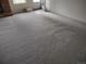Spacious living room with plush carpeting and a doorway to a tiled space at 6712 E Briarwood Dr, Centennial, CO 80112