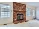 Living room featuring a brick fireplace and patio access at 6712 E Briarwood Dr, Centennial, CO 80112