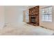 Living room with brick fireplace and carpet flooring at 6712 E Briarwood Dr, Centennial, CO 80112