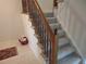Carpeted staircase with wooden railing leading to the upper level of the house at 6712 E Briarwood Dr, Centennial, CO 80112