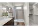 Neutral bathroom features a tiled shower and a modern vanity at 46501 Avery Ln, Bennett, CO 80102