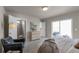 Bright main bedroom features a large closet, ensuite bathroom, and access to the balcony at 46501 Avery Ln, Bennett, CO 80102