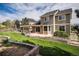 Spacious backyard with lush lawn, pergola covered patio, and beautiful landscaping, perfect for outdoor activities at 1076 Switch Grass Dr, Castle Rock, CO 80109