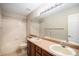 Bathroom with double vanity, tiled backsplash, and bathtub-shower combination at 1076 Switch Grass Dr, Castle Rock, CO 80109