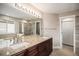Bathroom features a double sink vanity, a walk-in shower, and tile flooring at 1076 Switch Grass Dr, Castle Rock, CO 80109