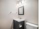 Powder room featuring vanity, mirror, and toilet at 1076 Switch Grass Dr, Castle Rock, CO 80109
