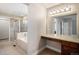 Bathroom with separate shower and tub, vanity, and walk through to closet at 1076 Switch Grass Dr, Castle Rock, CO 80109