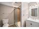 Bathroom featuring a white vanity, framed mirror, tiled shower with glass door, and a comfort height toilet at 1076 Switch Grass Dr, Castle Rock, CO 80109