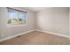Neutral bedroom featuring carpeted floors, baseboard trim, and a window at 1076 Switch Grass Dr, Castle Rock, CO 80109