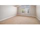 Spacious bedroom with neutral carpet, large windows, and ample natural light at 1076 Switch Grass Dr, Castle Rock, CO 80109